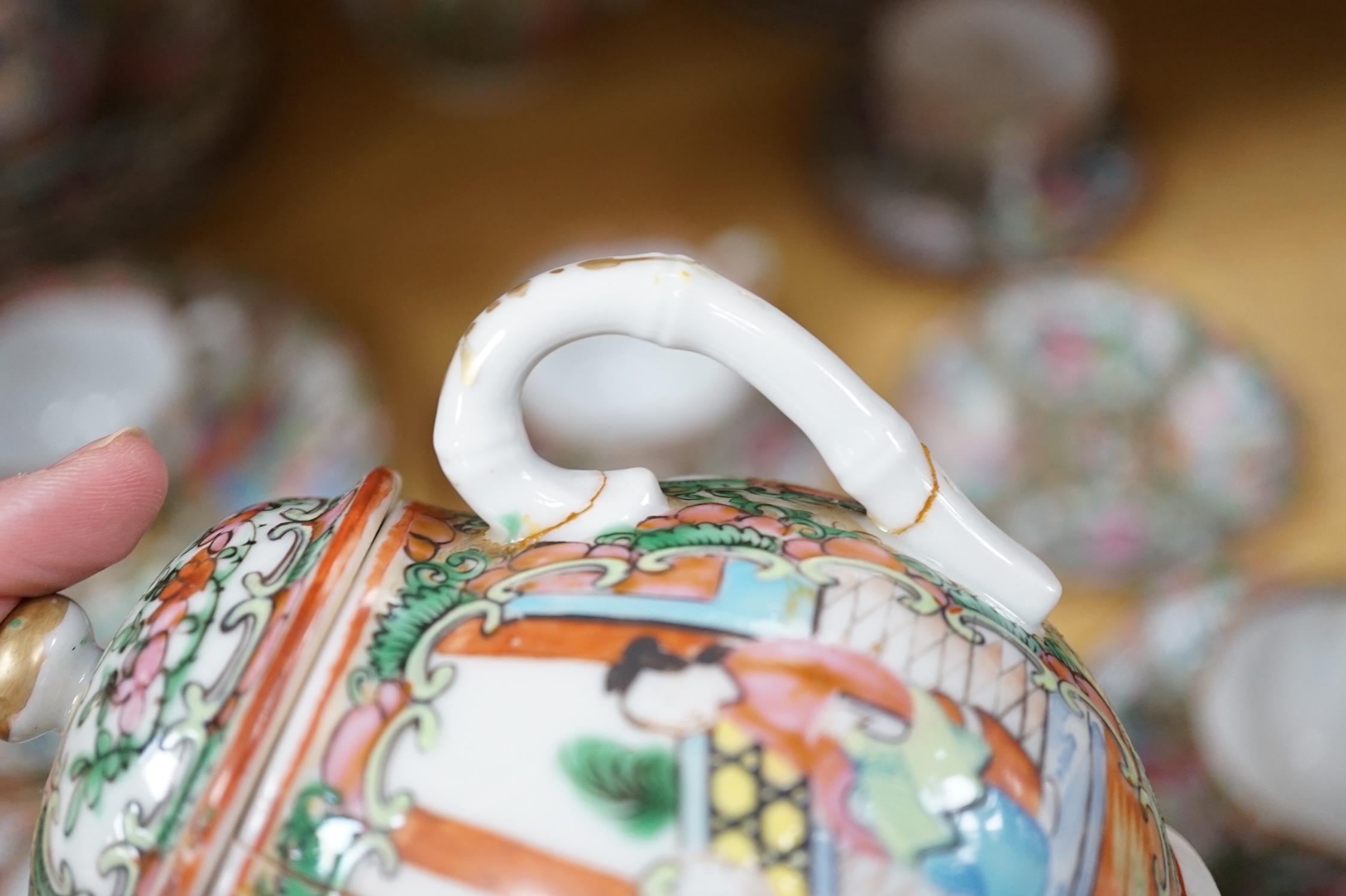 A Chinese famille rose part tea set including: five cups saucers and side plates, a teapot and cover, sugar bowl and cover, a cream jug, four cake plates and two square plates (27)